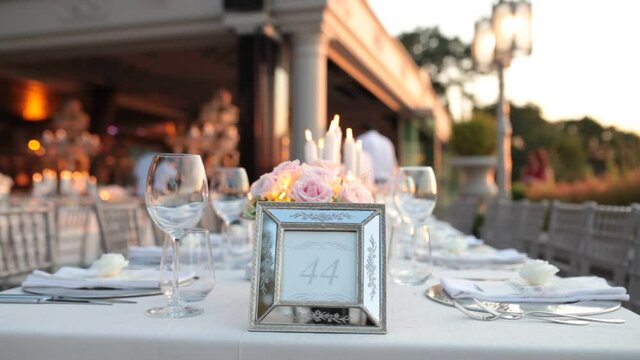 wedding day dinner table in hotel garden white close up. Wedding day cinematic wedding. save the date clip close up