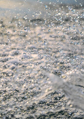 Splashing water in the rays of sunlight. Fun on the beach, background	