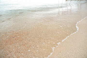 calm sea, small waves, clear and transparent water, small sand near the shore