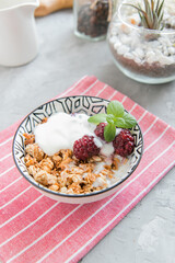 Muesli with yogurt and berries in a plate on the table