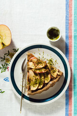 italian apple pie crostata with pistachio crumbs on the table with a white tablecloth