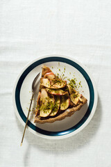 italian apple pie crostata with pistachio crumbs on the table with a white tablecloth