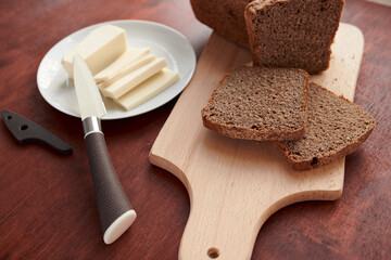 healthy food - fresh bread and feta cheese on a wooden background