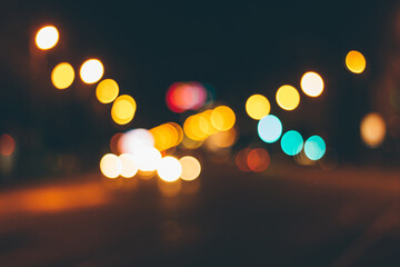 Blurred night road background with bokeh cars
