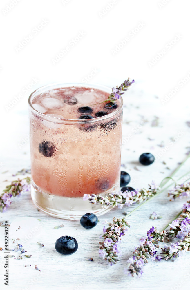 Sticker Cold carbonated lemonade (soda) with blueberries and lavender syrup. Soft focus. Place for text. Copy Space