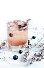 Cold carbonated lemonade (soda) with blueberries and lavender syrup. Soft focus. Place for text. Copy Space