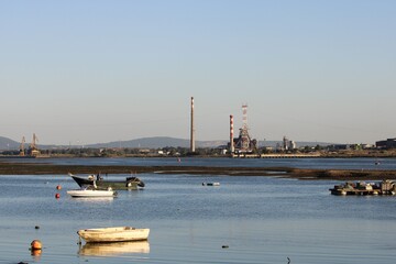 Ship in the port with the chimneys in the horizon © Patty