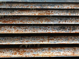 Old iron jalousie in old house. Multicolor, rust, old paint