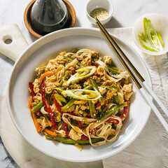 Thailand street food - Pad Thai with tofu in a plate on a table, in a restaurant or cafe