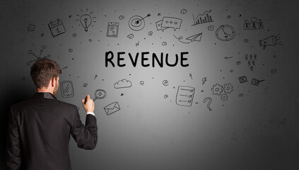 businessman drawing a creative idea sketch with REVENUE inscription, business strategy concept