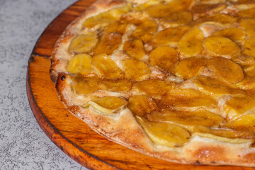 Sweet pizza with banana and cinnamon. Traditional Brazilian sweet pizza with banana.