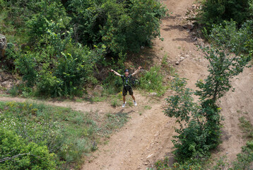 A guy in the helmet and special equipment is very happy and smiles after rope jumping from the...