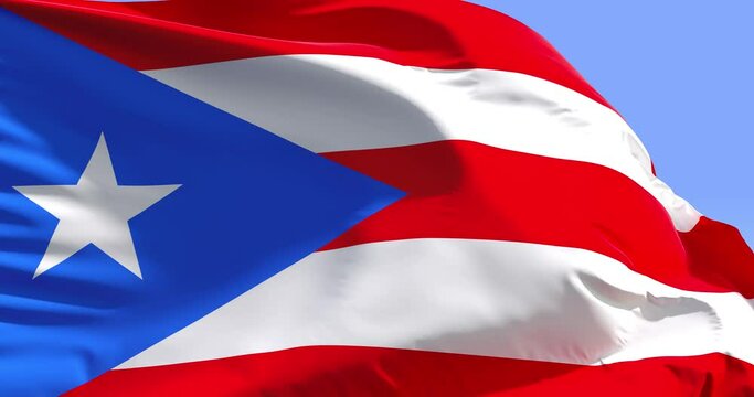 Puerto Rico flag on a flagpole. Wonderful intro for yor projects. The Commonwealth of Puerto Rico.