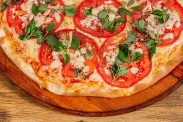 Margherita pizza on wooden background