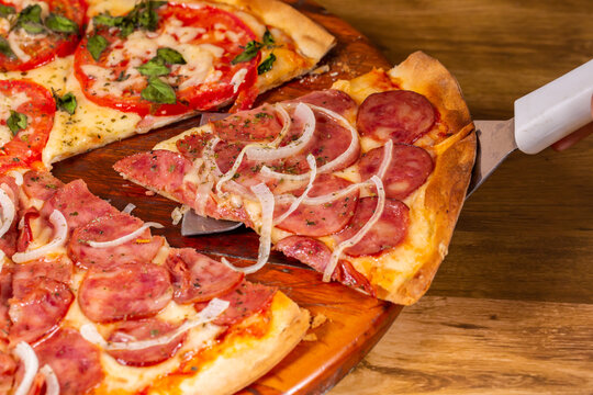 Slice of pepperoni pizza. Brazilian pizza called pizza de calabresa