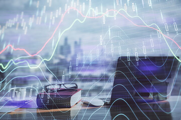 Double exposure of financial chart drawings and desk with open notebook background. Concept of forex market