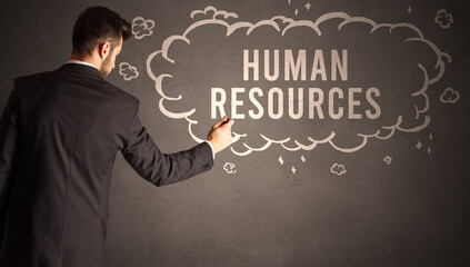 businessman drawing a cloud with HUMAN RESOURCES inscription inside, modern business concept
