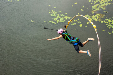 Ivanovsky Bridge, Ukraine - June 21, 2020: Concept of Extreme Sport. The  girl is  doing rope...