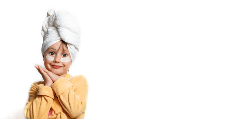 Cute girl in a yellow bathrobe with eye patches