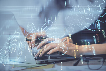 Fototapeta na wymiar Multi exposure of woman hands typing on computer and financial graph hologram drawing. Stock market analysis concept.