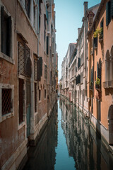 Fototapeta na wymiar Narrow canal of Venice in Italy