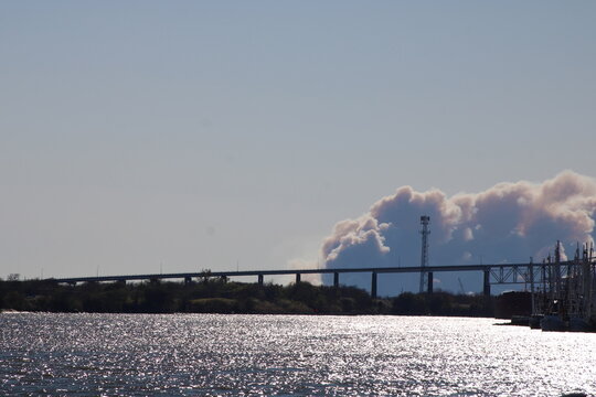 smoke from a factory, sky, industry, factory, water, bridge, sea, power, industrial, smoke, blue, pollution, winter, landscape, travel, plant, city, clouds, snow, river, building, pier, sun, tower,