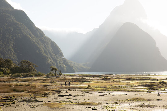 A Couple In The Fjords Underneath A Plane In New Zealand