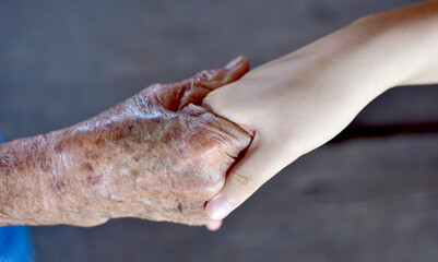 Close up of Elderly Asian women and young asian woman holding hands. Concept of family relations, Selective Focus.