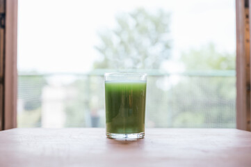 Green juice on a wooden table