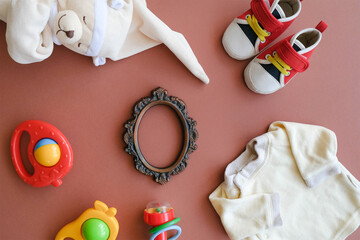 Fototapeta na wymiar Baby goods and frame with copy space. Accessories for infant baby boy.