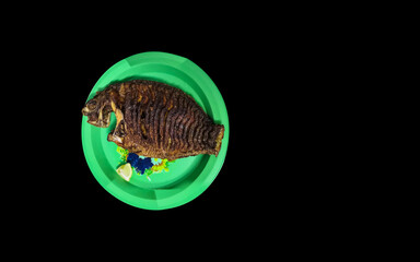 fish fry with plate isolated on black background