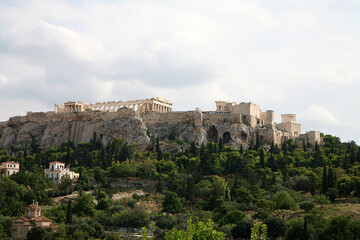View of Acropolis in Athens Greece with stormy sky and plants in foreground