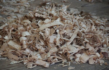 A pile of wood shavings on the floor