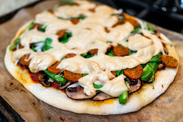 Homemade gluten free pizza crust cooked baked with tomato sauce, toppings of green bell peppers...