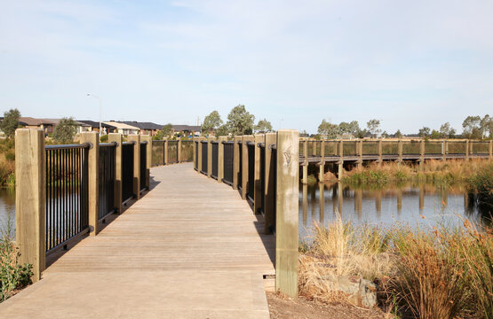 Housing estate located in Clyde North, near Berwick, Victoria featuring lake surrounded by plants and walking tracks.  The future of urban housing and green space