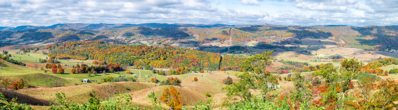 Colorful Fall Maple Trees And Farm House Land Rolling Hills Aerial Above High Angle View Landscape Panorama In Blue Grass, Highland County, Virginia