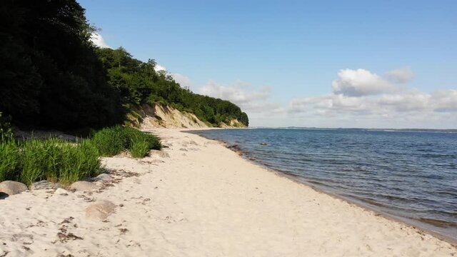 Beautiful beach in northern Germany, Schleswig-Holstein called Noer Beach on the Baltic Sea.
Drone flies from right to the left in a low altitude