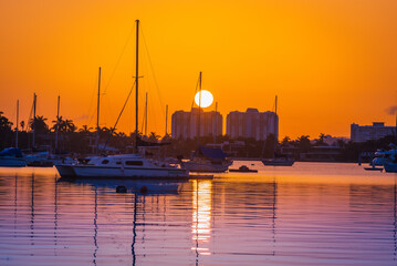 Fototapeta na wymiar marina at sunrise miami florida sun summer sea city buildings sunset boats reflection 
