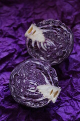 Fototapeta premium red cabbage cut close-up on a bright crumpled purple background.Fresh bio farm organic vegetables.Red Cabbage Cooking Recipe.Healthy diet bright vegetable