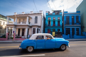 Havana, Cuba in February 2018. Traditional and colorful old cars with old buildings in the background.