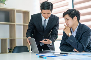 Two young asian businessman working together on business planning in the office.