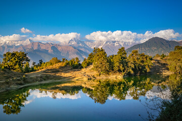 Mesmerizing view at Deoria Tal or Lake nestled in Garhwal Himalayas at  Chopta, Uttarakhand, India. This lake is a camping location for Tungnath Chandrashila hiking trail.