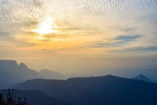 Spectacular silhouette view during sunset in Sahyadri mountain range on a winter evening from Sunset point at Matheran, Maharashtra, India.