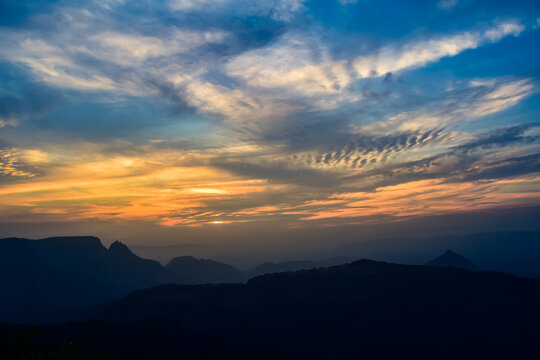 Spectacular silhouette view during sunset in Sahyadri mountain range on a winter evening from Sunset point at Matheran, Maharashtra, India.