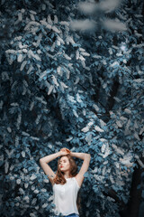 Portrait of woman on a background of blooming bird cherry.