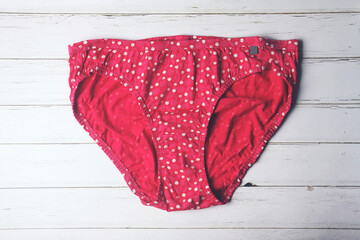 Female cotton set panties on woodeb table	
