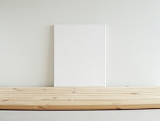 Blank canvas frame mockup on wooden shelf, empty frame mock-up for artwork, photo, painting, minimal interior.