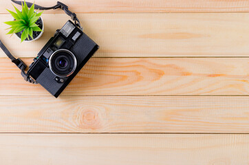Vintage camera on wooden table background with copy space. World photography day conept.