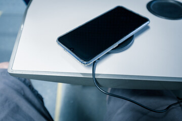 charging the phone with a wireless charger while traveling by train