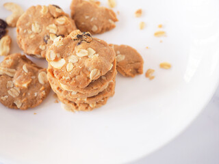 Fototapeta na wymiar Healthy homemade oat cookies on white plate background. Top view , close-up..